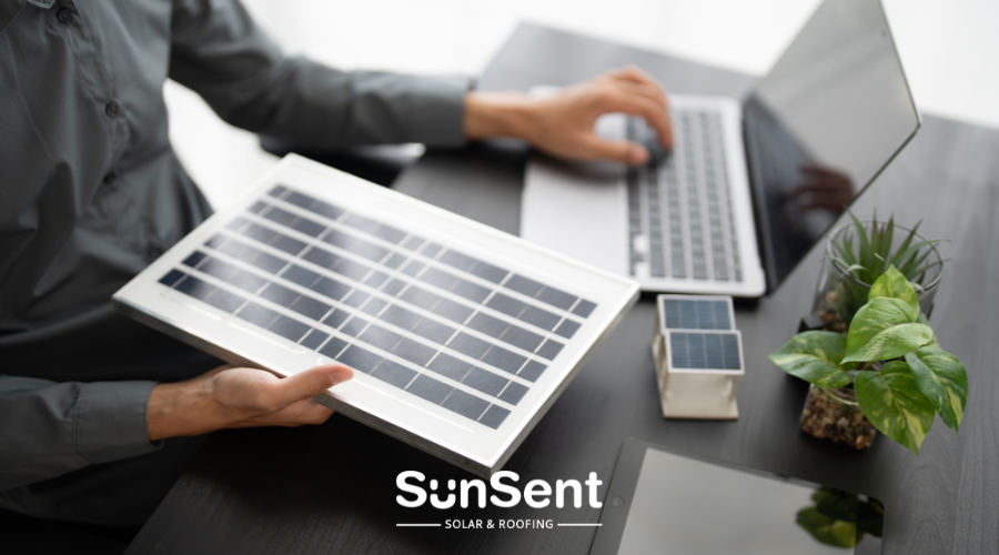 SunSent Solar & Roofing consultant reviewing a solar panel system and cost estimate on a laptop.