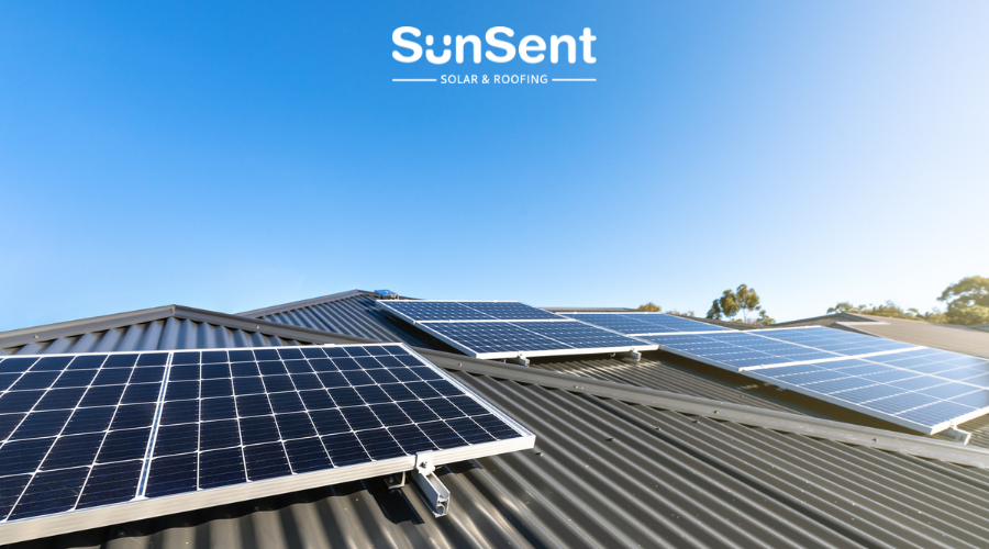 Rooftop solar panel installation by SunSent Solar and Roofing on a metal roof with clear skies